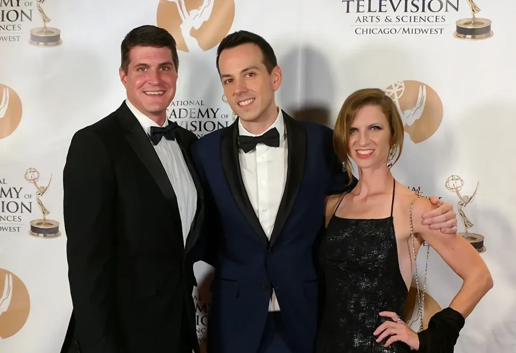 The See It Media team in formal attire smile for a group photo at an awards ceremony.